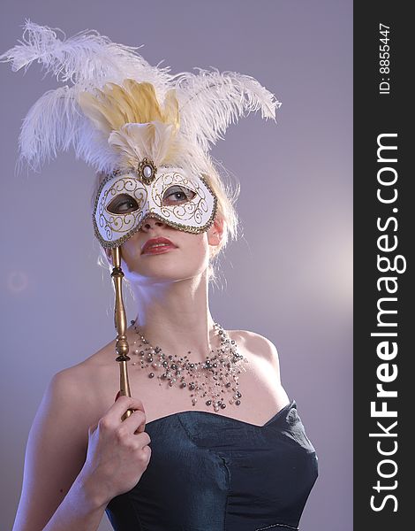 Beautiful young woman with Venetian mask, studio photo. Beautiful young woman with Venetian mask, studio photo