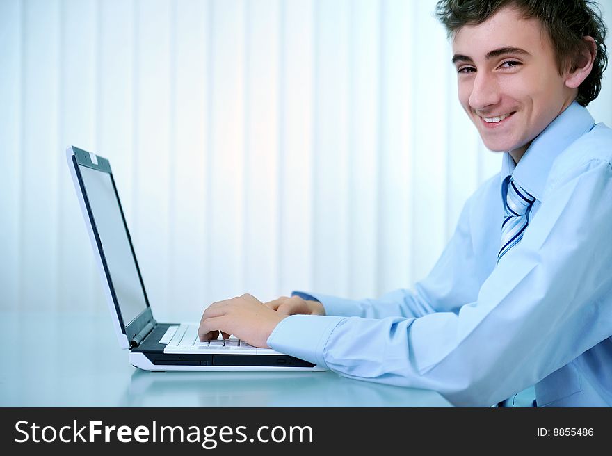 Young businessman using computer laptop in office. Young businessman using computer laptop in office