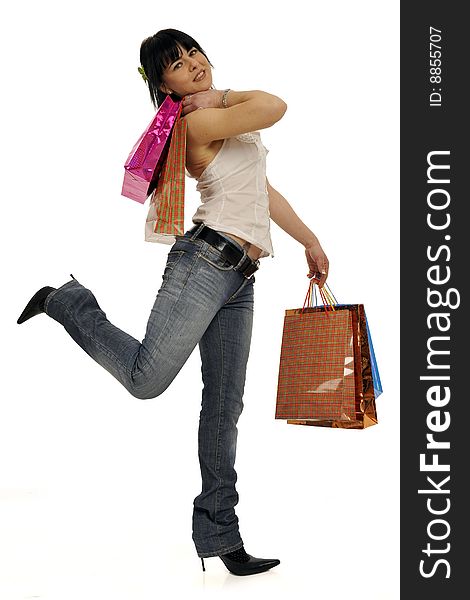 Full body view of young attractive woman going shopping with lots of colorful shopping bags. Isolated on white background. Full body view of young attractive woman going shopping with lots of colorful shopping bags. Isolated on white background.