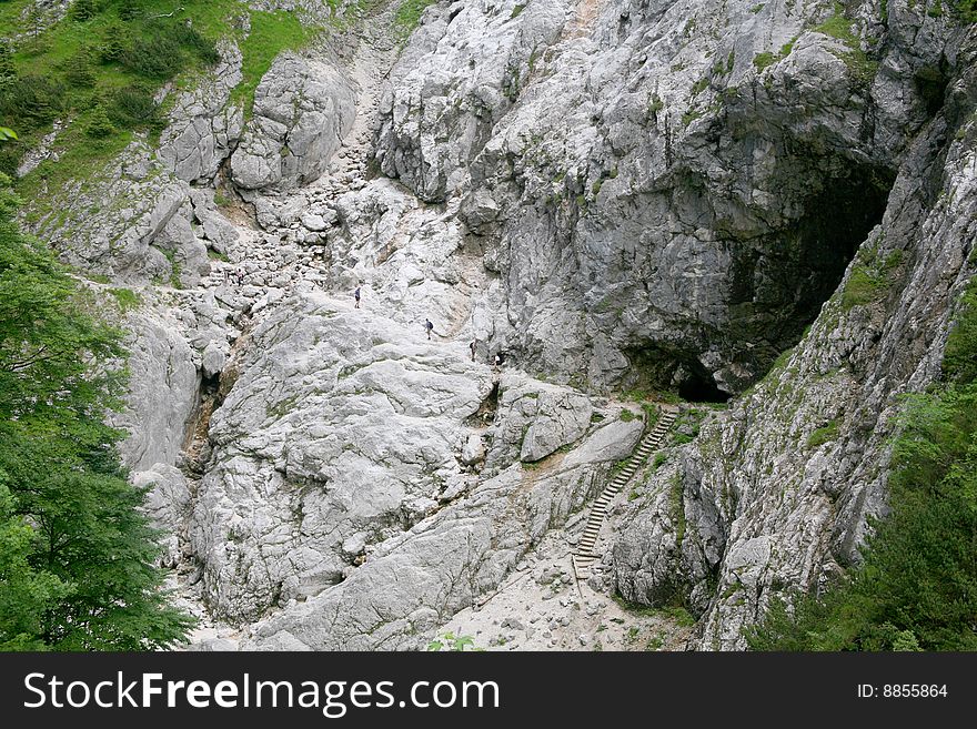 Group of people climbing a mountain near Zugspitze, Garmisch, in a streep path. Group of people climbing a mountain near Zugspitze, Garmisch, in a streep path