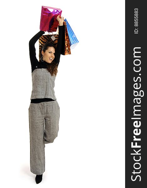 Full body view of young attractive woman in business wear, going shopping with lots of colorful shopping bags. Isolated on white background. Full body view of young attractive woman in business wear, going shopping with lots of colorful shopping bags. Isolated on white background.