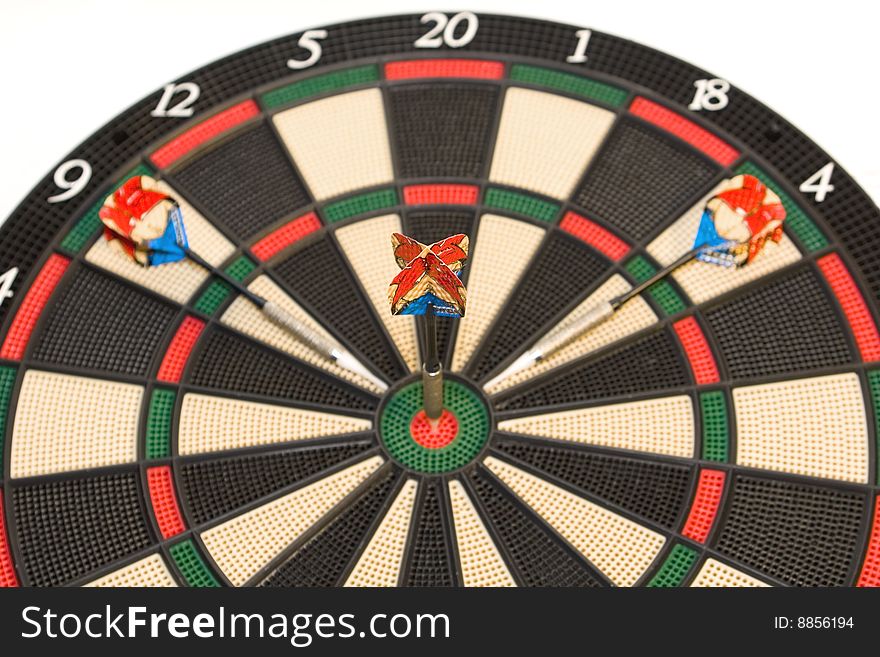 Three darts on colored dartboard