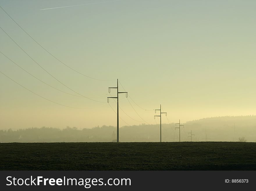 Electricity lines, power lines on green field