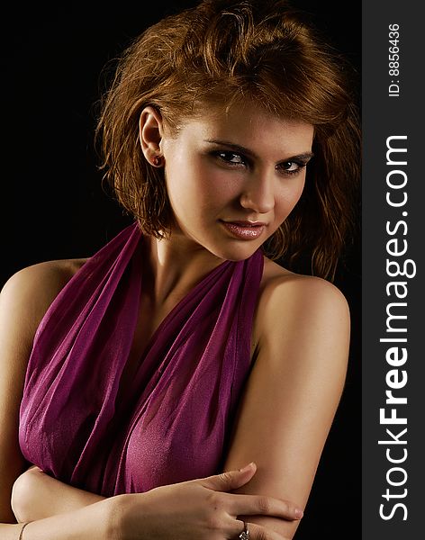 Glamour girl posing with pink scarf on black background