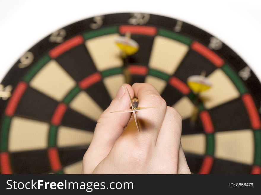 Shallow depth of field shot of darts in bullseye on dartboard