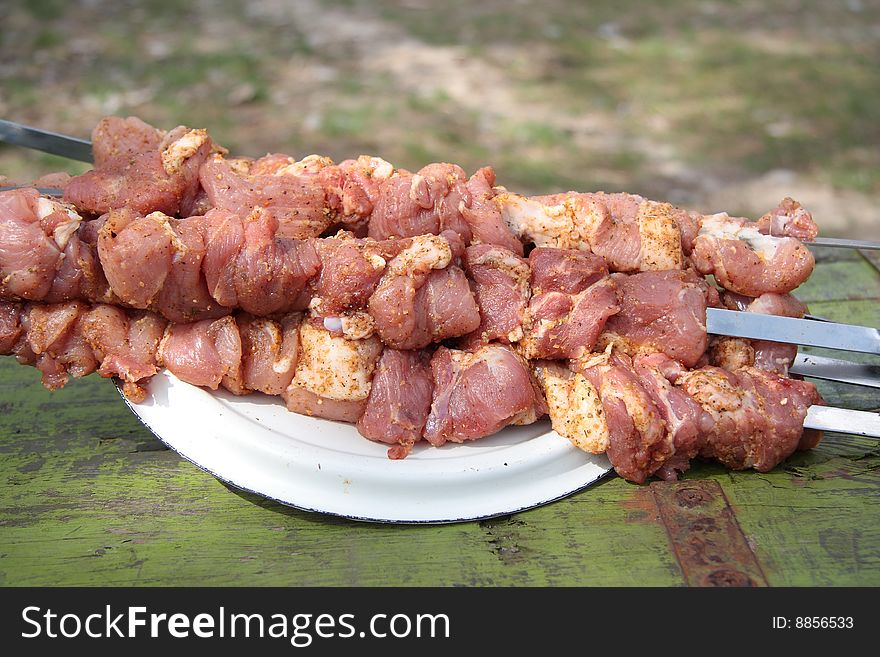 Pieces of raw meat on the skewer dressed for barbecue. Pieces of raw meat on the skewer dressed for barbecue