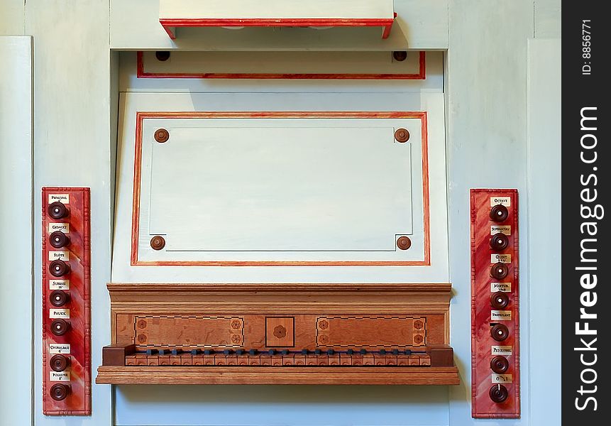 Old wooden organ controls and keyboard