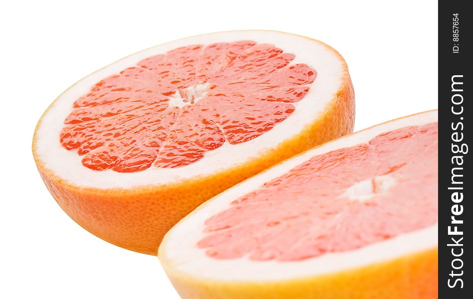 Closeup of grapefruit halves isolated on white. shallow dof