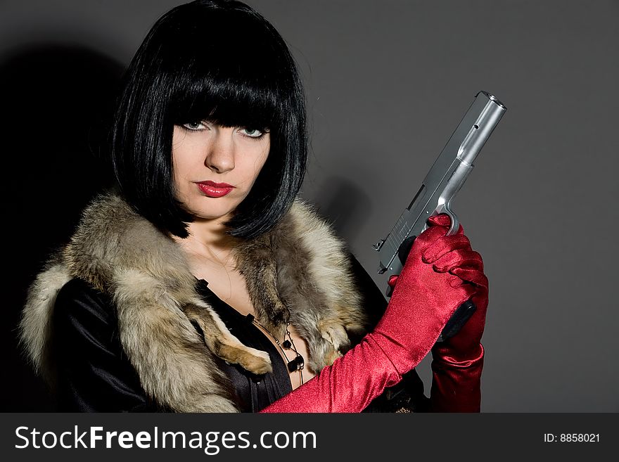 Retro portrait of lovely brunette woman with gun. Retro portrait of lovely brunette woman with gun