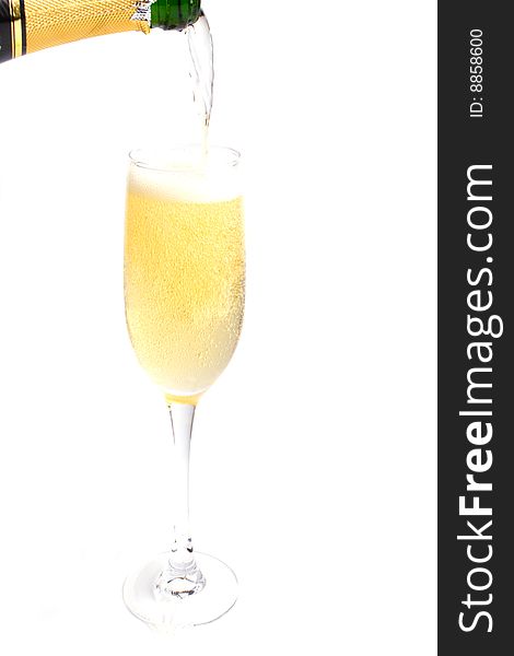 Champagne being poured into glass isolated on white background.