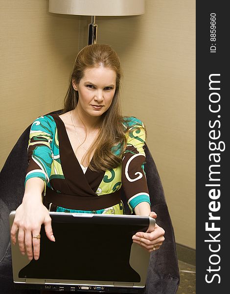 Young Female Sitting with Laptop Computer on Chair