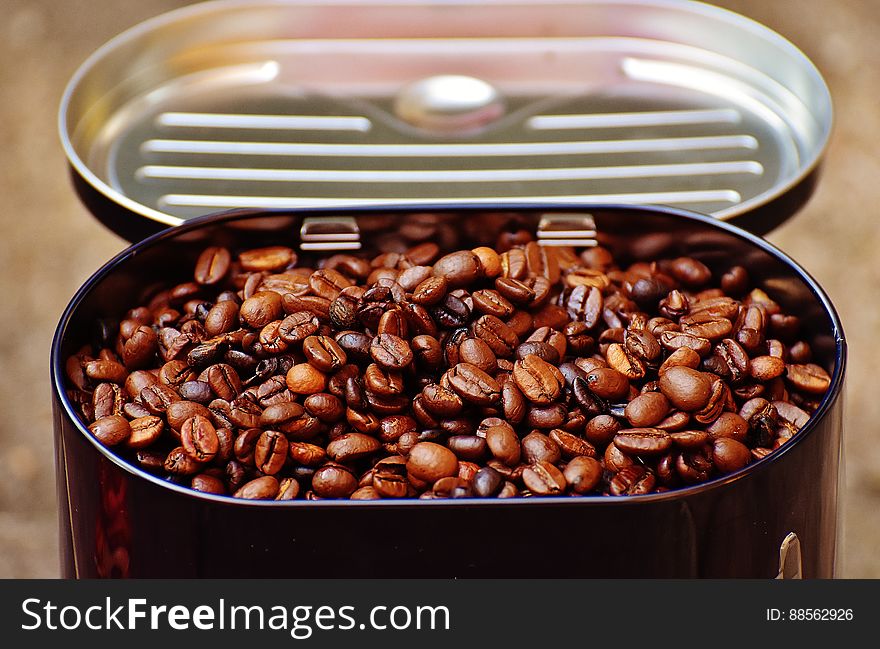 A tin of roasted coffee beans.