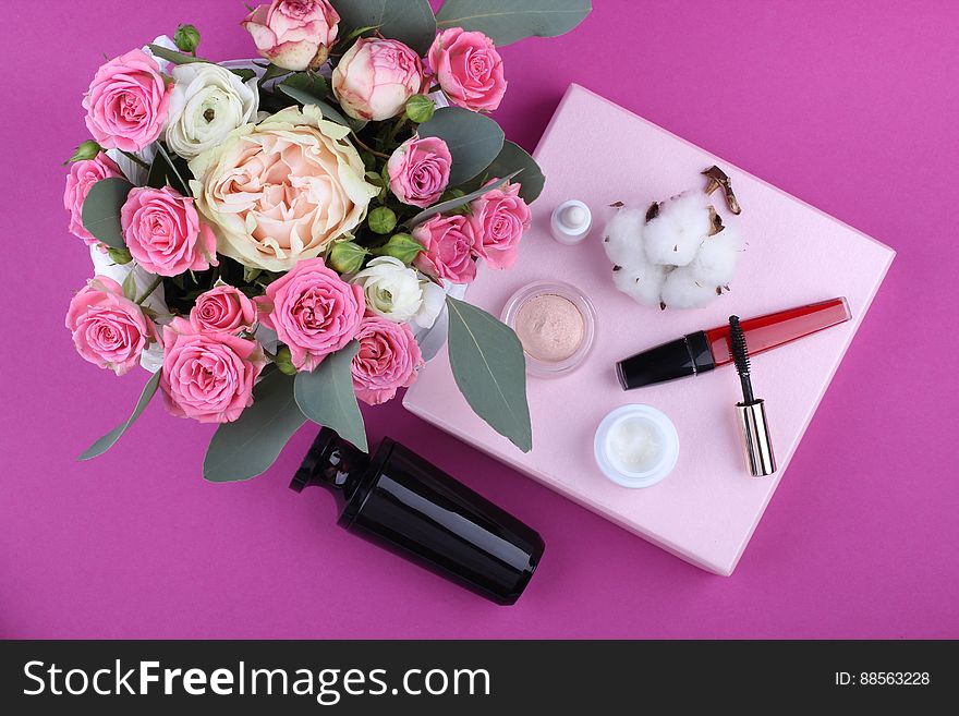 A bouquet of flowers and make-up equipment with cotton buds. A bouquet of flowers and make-up equipment with cotton buds.