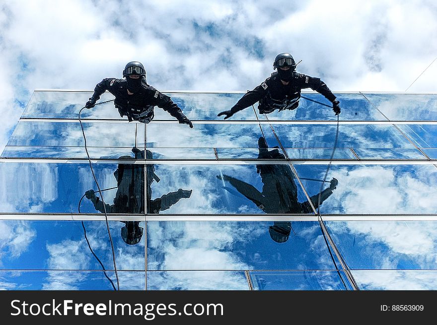 Gendarmes climbing down a building using ropes. Gendarmes climbing down a building using ropes.