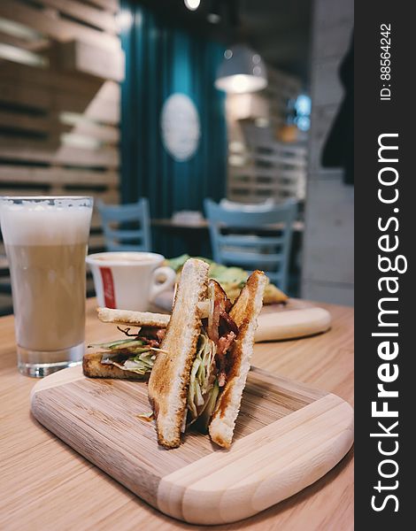 A close up of toast sandwiches and beer on a table in a cafe. A close up of toast sandwiches and beer on a table in a cafe.