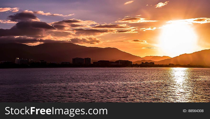 A sunset over a city seen from the sea. A sunset over a city seen from the sea.