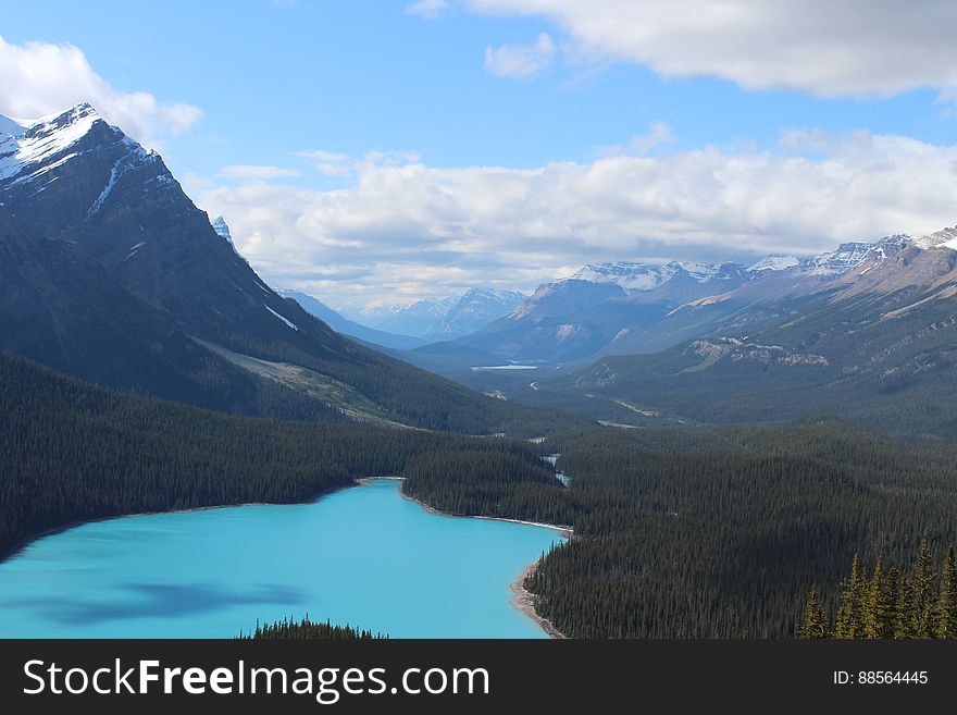 A valley with a blue lake in a valley between the mountains. A valley with a blue lake in a valley between the mountains.