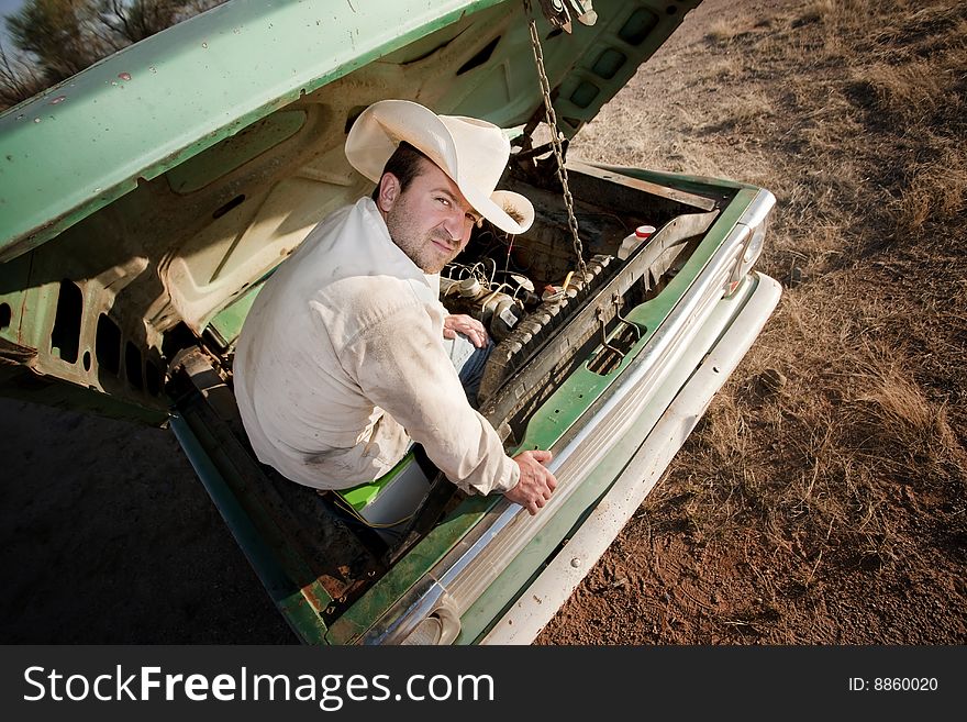 Man Under The Hood Of His Truck