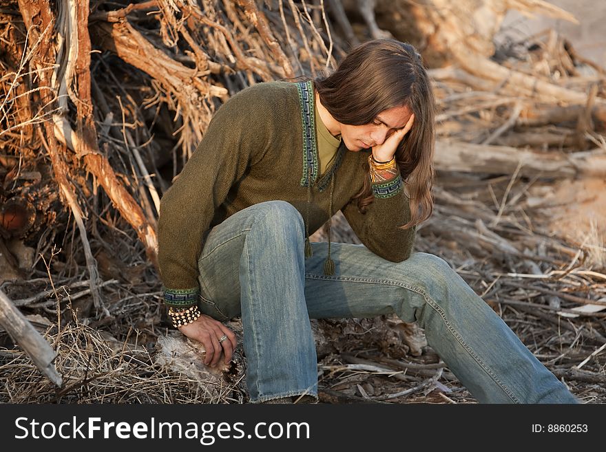 Handsome young man with long hair in an outdoor setting