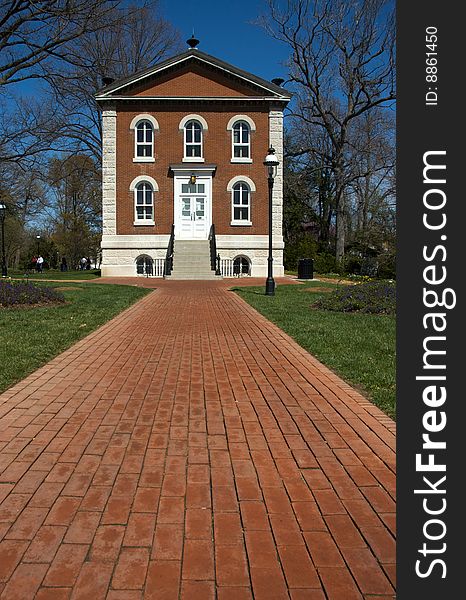 Two-story brick and stone home and red brick walkway. Two-story brick and stone home and red brick walkway.