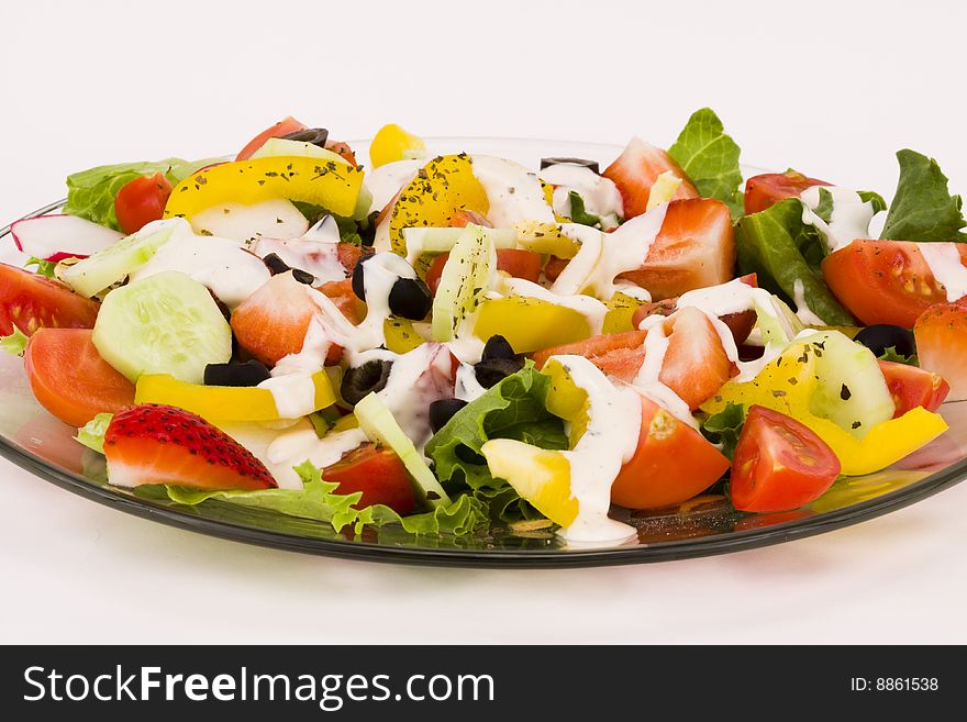 Fresh vegetables salad with creamy dip on a white background. Fresh vegetables salad with creamy dip on a white background