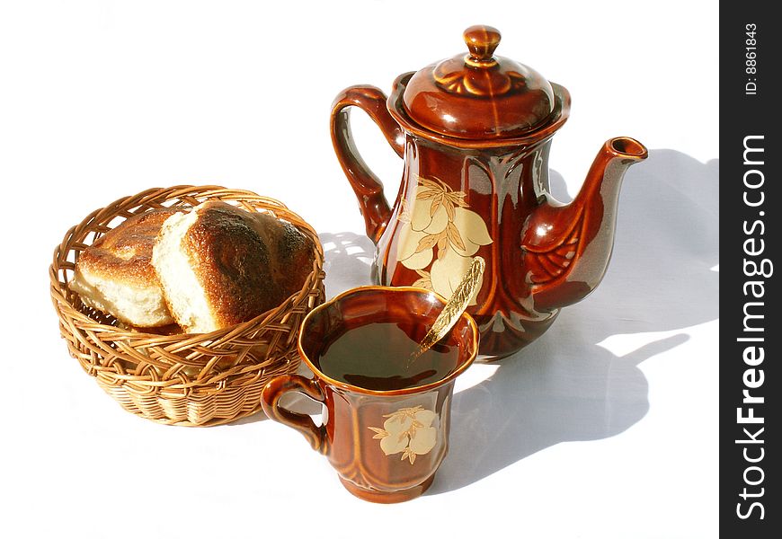 Still-life with buns in a wicker-work vase and tea set. Still-life with buns in a wicker-work vase and tea set.