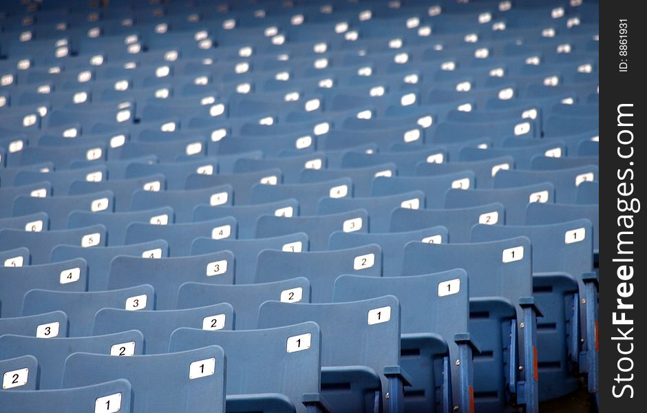 Row of blue empty seats at a sports arena. Row of blue empty seats at a sports arena