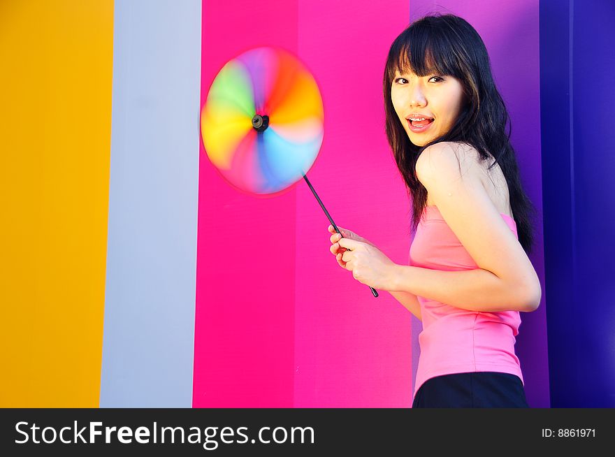 Beautiful Chinese girl playing with windmill toy