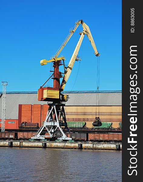 Crane loading wagons in sea port. Crane loading wagons in sea port