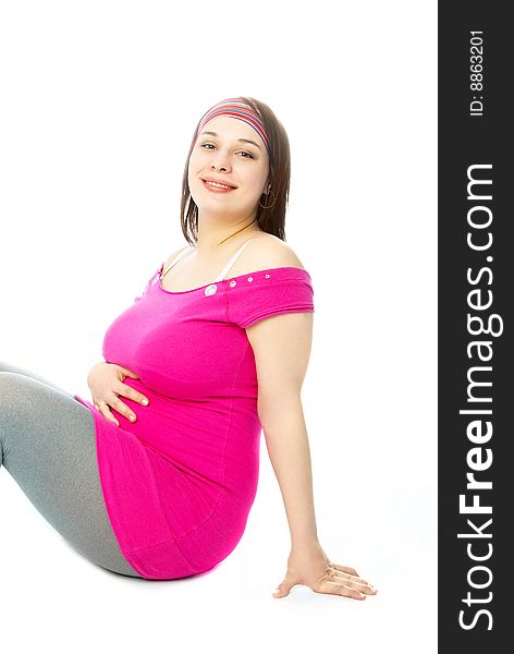 Portrait of a happy beautiful pregnant woman sitting on the floor. Portrait of a happy beautiful pregnant woman sitting on the floor