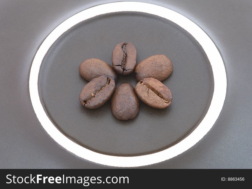 Coffee beans on the brown backgound