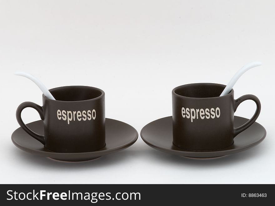 Two coffee cups with white tea-spoons