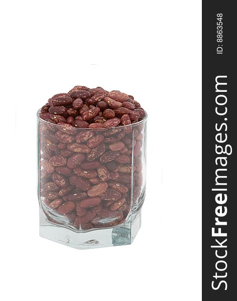 Haricot beans in the transparent glass isolated over white