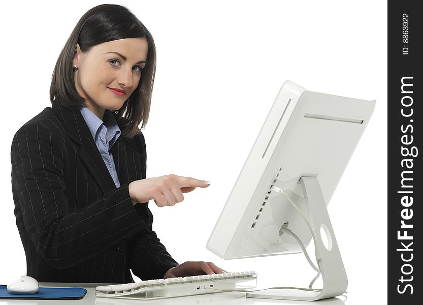 Beautiful businesswoman in her office indicating something on laptop