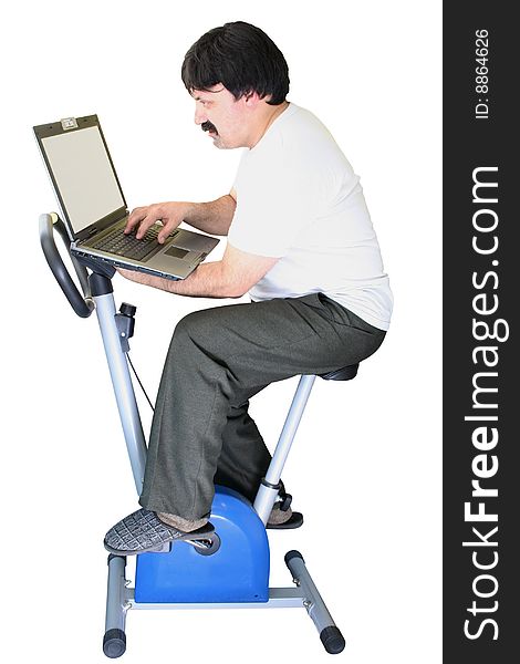 Fat man exercising on a veloergometer and working on PC.