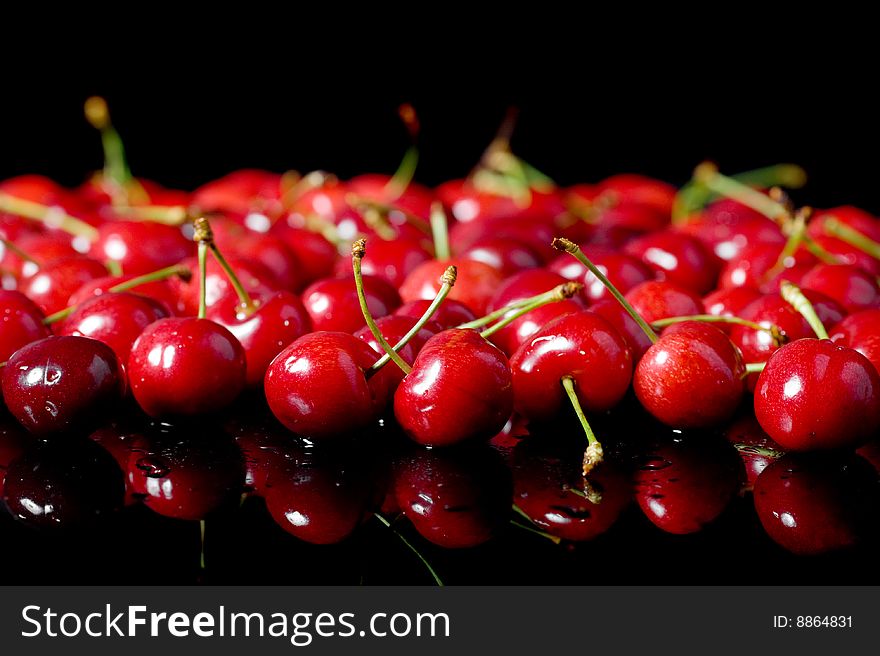Red cherries on black background