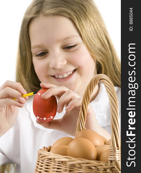 Cute little girl painting easter eggs