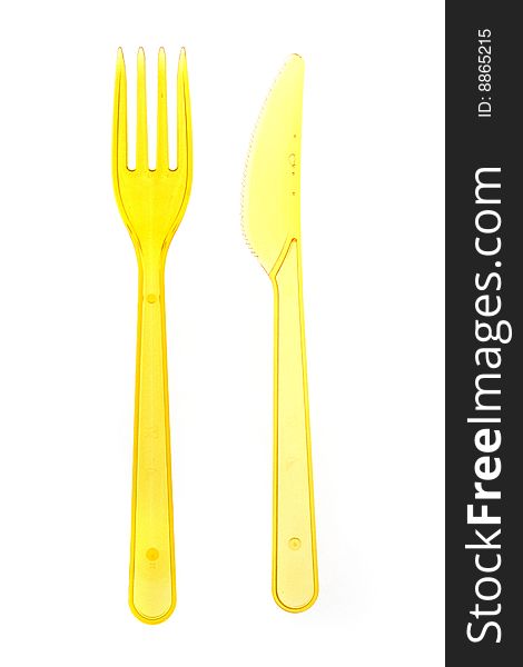 Yellow knife and fork isolated on white