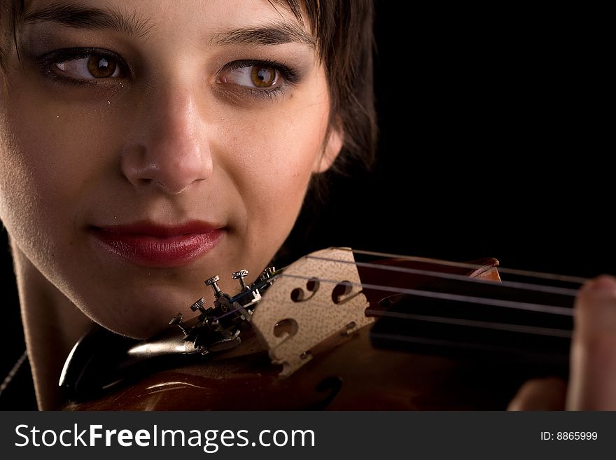 Young woman playing the violin closeup. Young woman playing the violin closeup