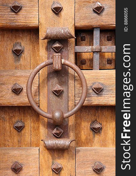 Old brown wooden door with an iron door knocker. Old brown wooden door with an iron door knocker