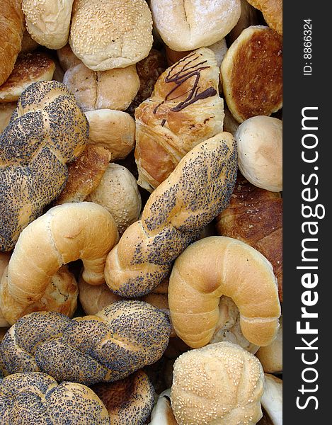 Bread and buns are on a table, background