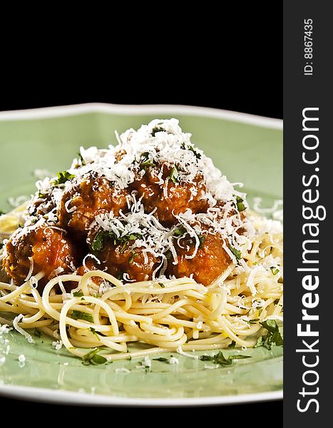 Spaghetti and meat balls with tomato sauce garnished with basil. Spaghetti and meat balls with tomato sauce garnished with basil