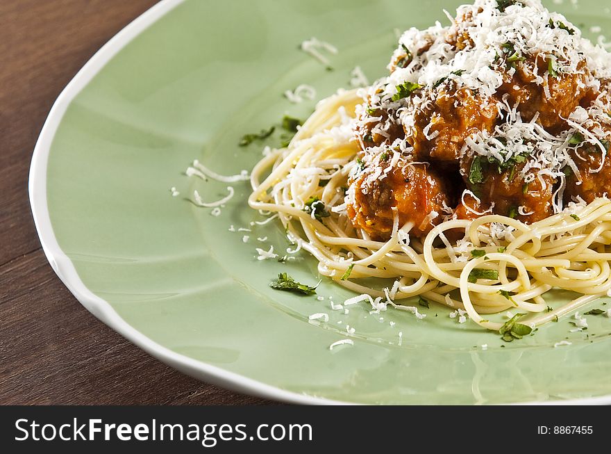 Spaghetti and meat balls with tomato sauce garnished with basil. Spaghetti and meat balls with tomato sauce garnished with basil