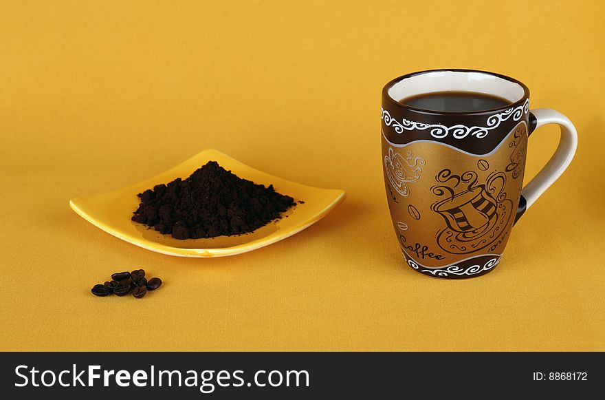 Coffee in three conditions: in the grains, ground, ready (a brown mug, a yellow background)