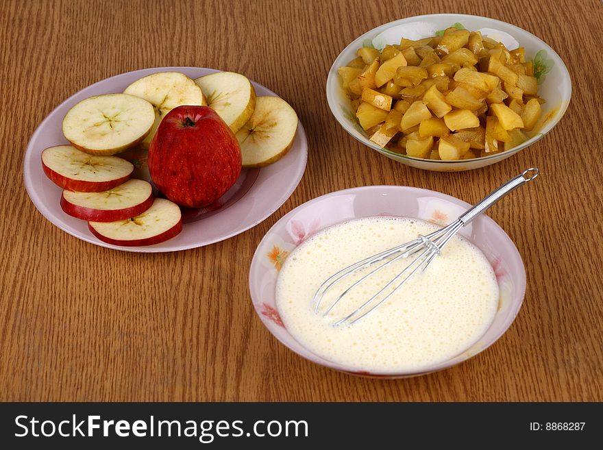 Components for cheese cake: the apples the segments baked and the shaken up cheese weight