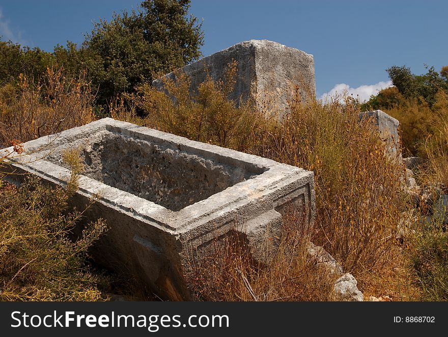 An overturned sarcophagus (stone coffin) lid in Ucagiz, Turkey. An overturned sarcophagus (stone coffin) lid in Ucagiz, Turkey