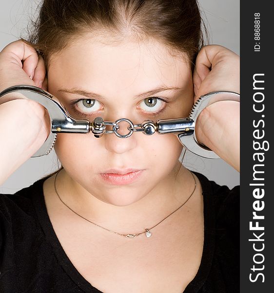 Young beautiful woman with hands in handcuffs. Young beautiful woman with hands in handcuffs