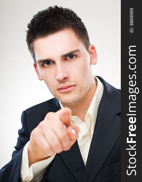 Young business man pointing accusing finger close up