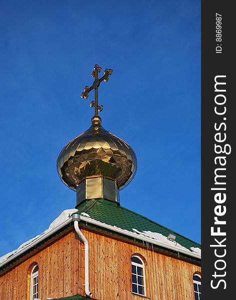 Cross of orthodox church against blue sky