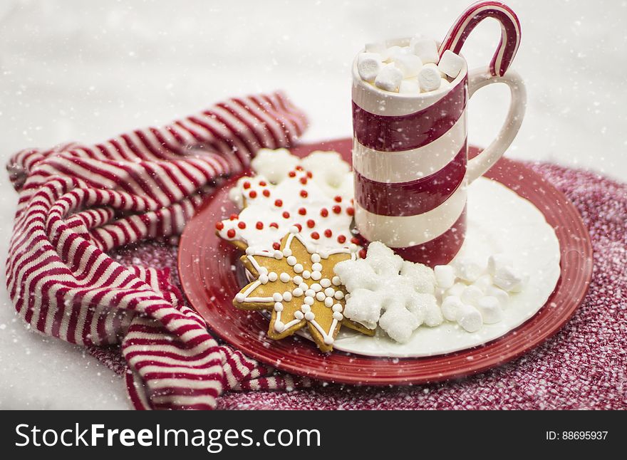 A cup of hot chocolate with gingerbread cookies on a plate. A cup of hot chocolate with gingerbread cookies on a plate.